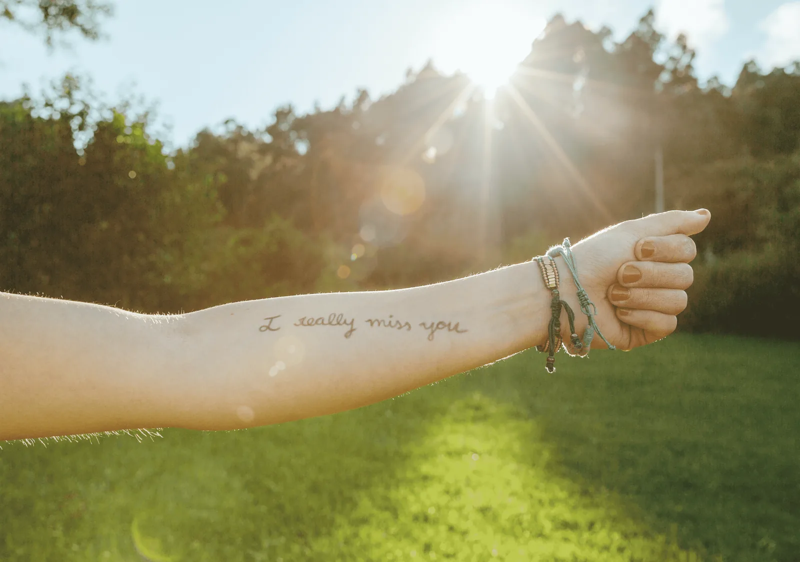 Inspirational quote scripted along the forearm