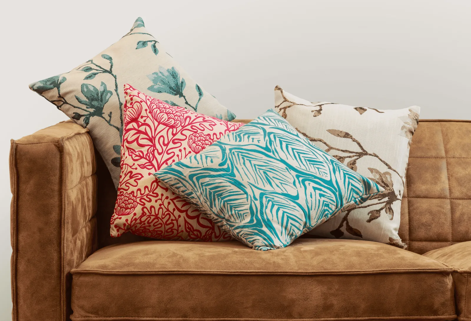 Cowhide print pillow covers with braided leather fringe