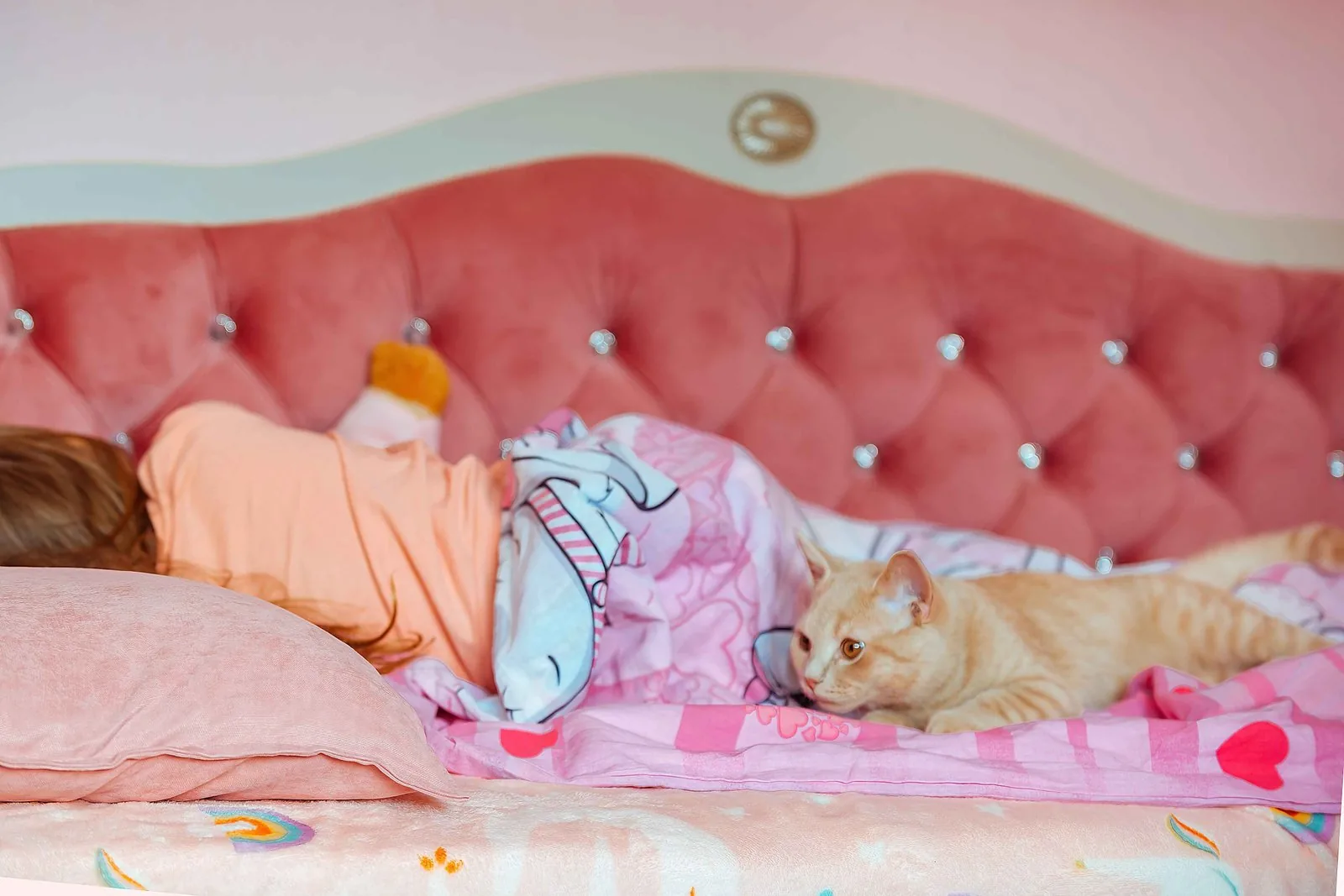 White Hello Kitty nightstand beside a themed bed
