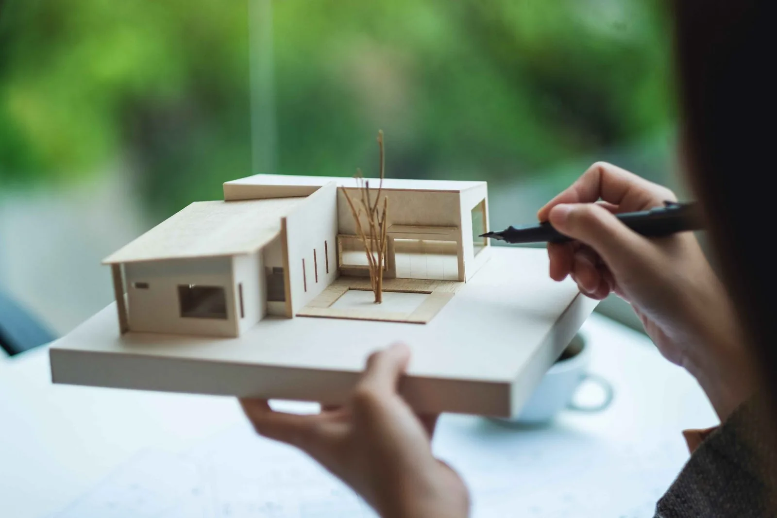 Architect working on a 3D home design on a computer
