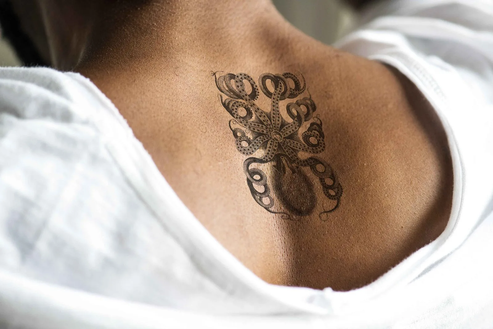 Close-up of script name tattoo on back of neck