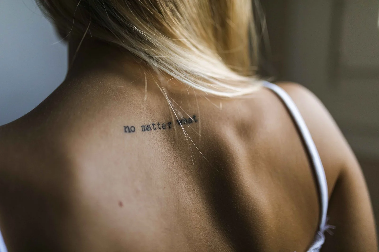 Stylish lettering name tattoo on neck