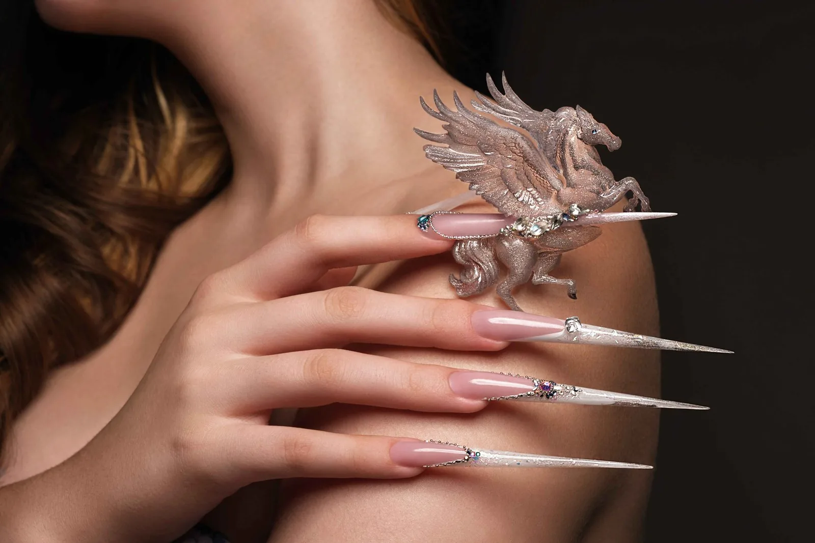 White nail ideas with intricate nail art on a woman's hands