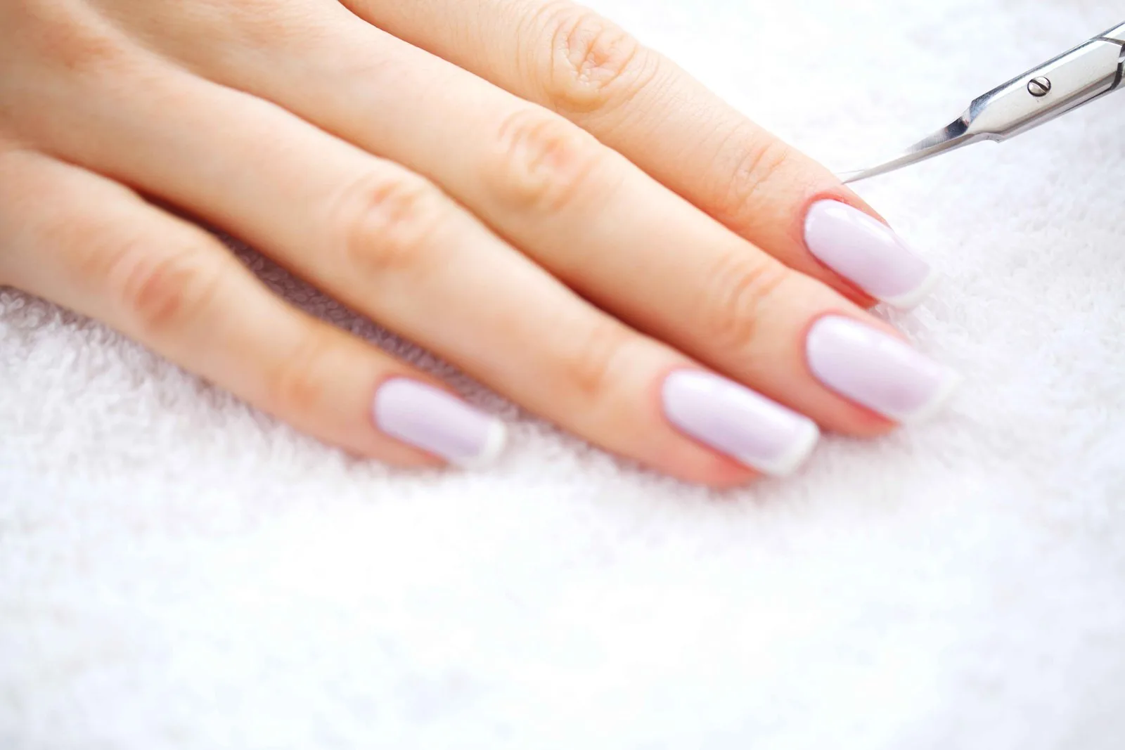 Classic French manicure with white tips done at a salon