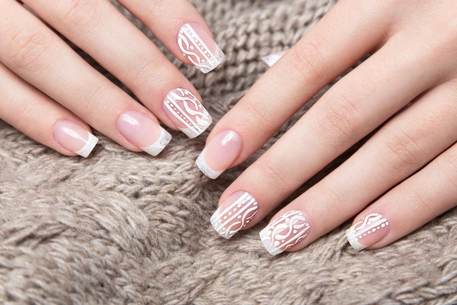 White nail art design with delicate patterns on winter nails