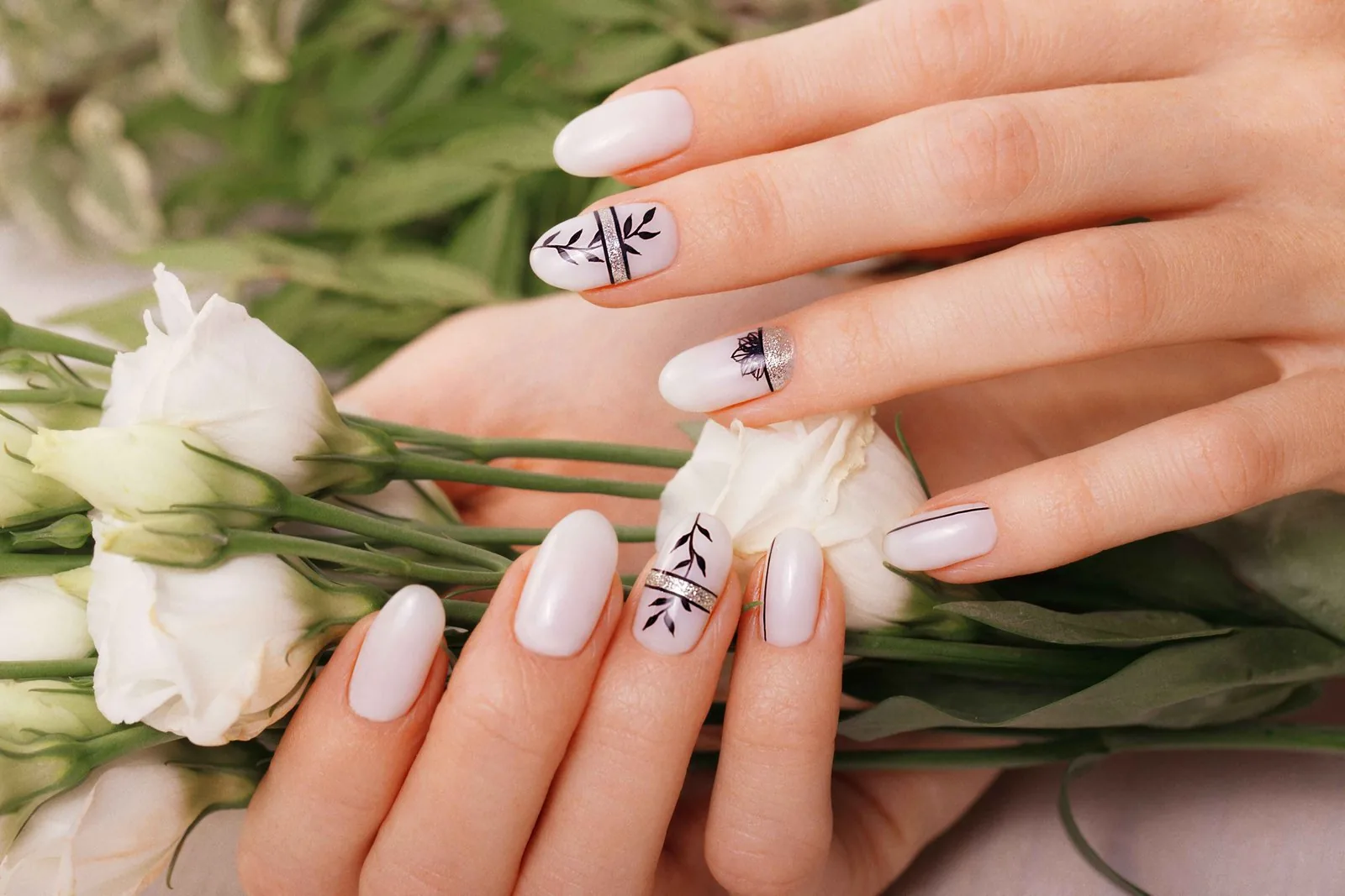White nails with negative space design and sheer glitter