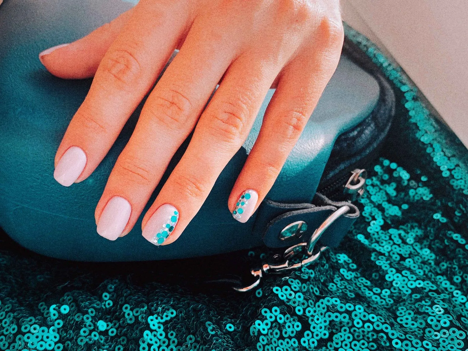Iridescent glitter accent nails over a white base