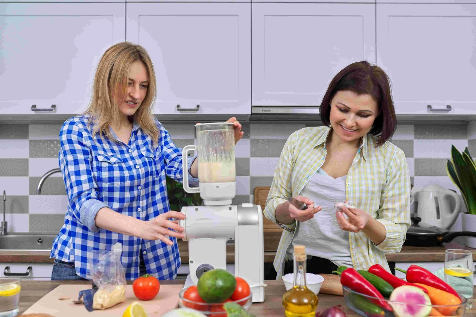 Two women cooking together in a home kitchen trying new hacks