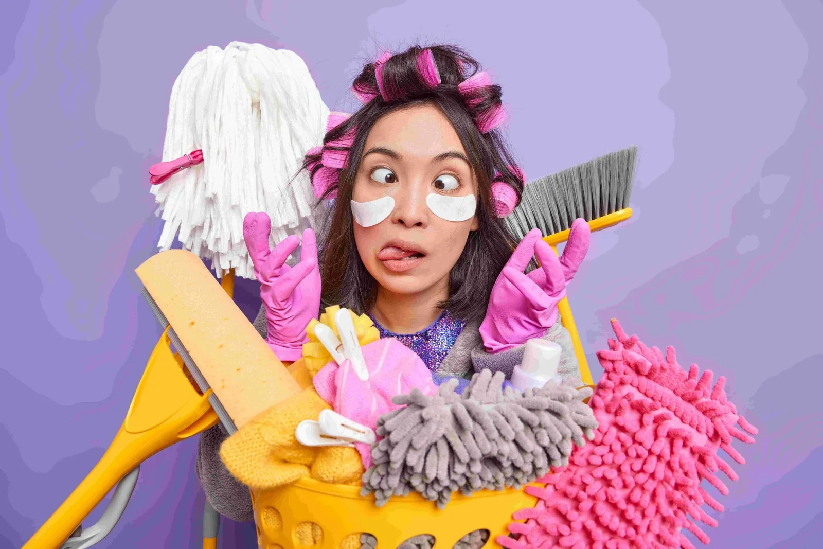 Woman making a funny face while cleaning the house