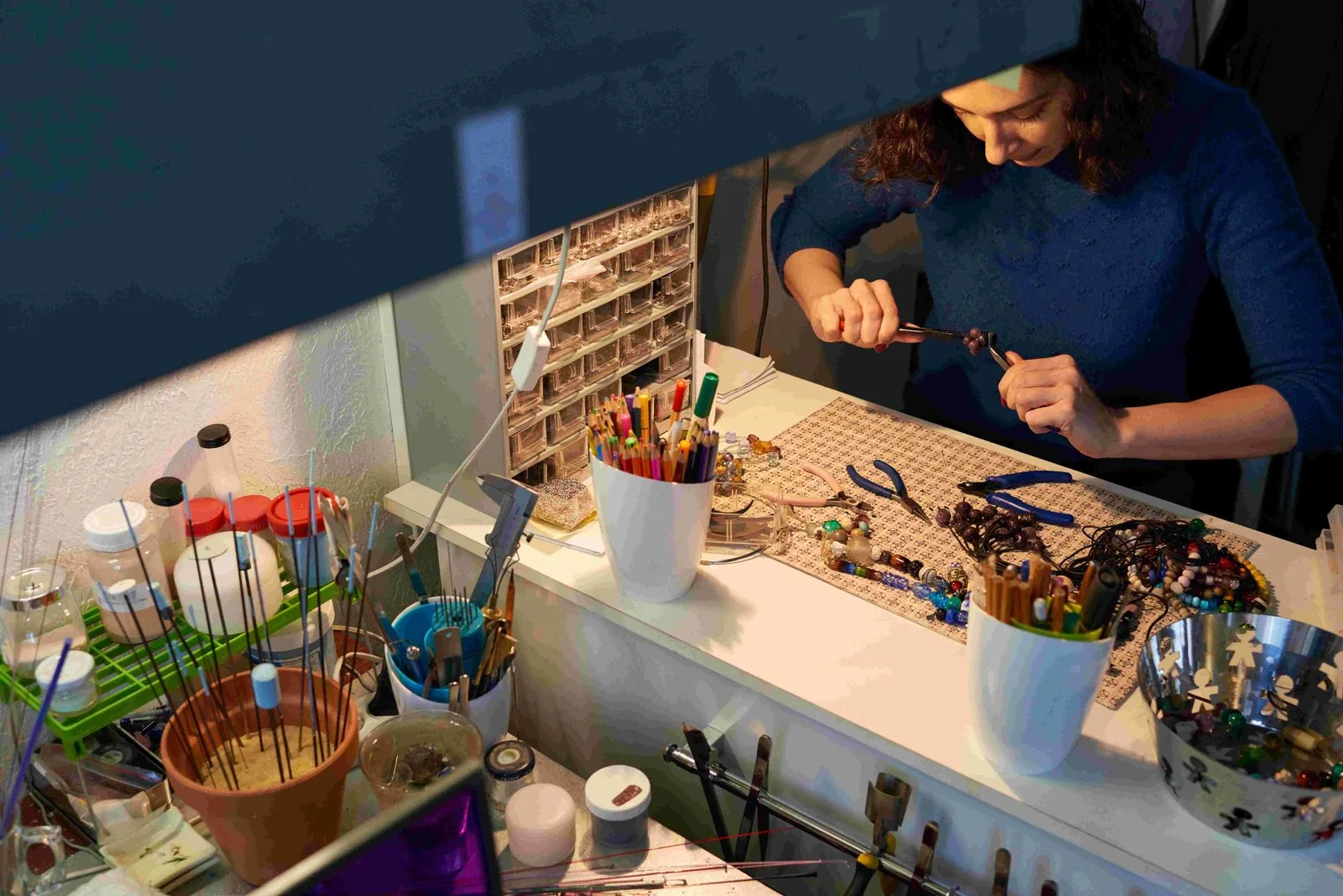 Creative woman organizing a workspace with clever storage ideas