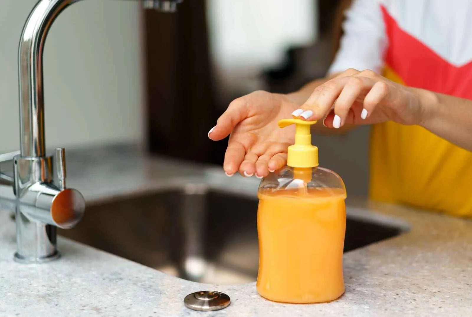 Different types of kitchen soap dispensers on a countertop