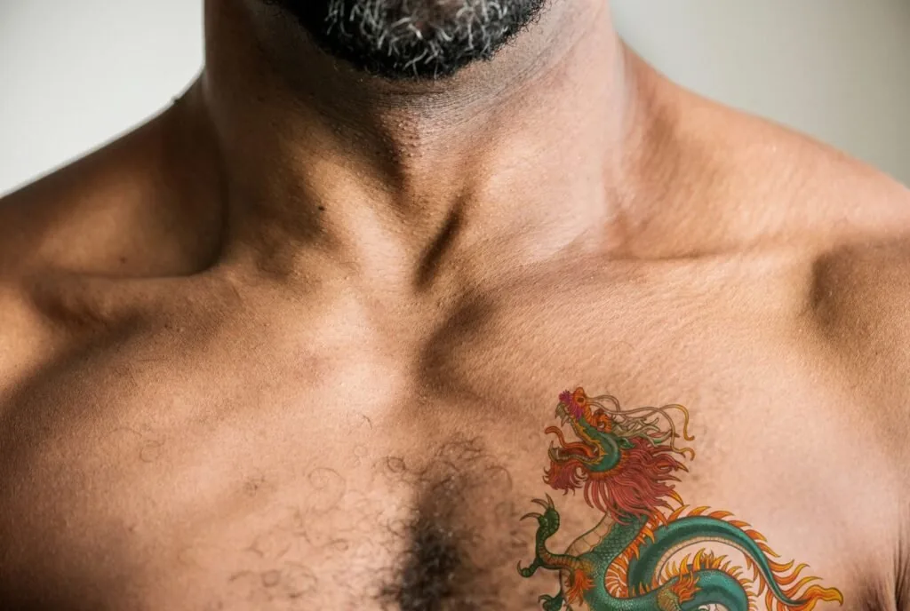 Confident man with finished tattoo sleeve