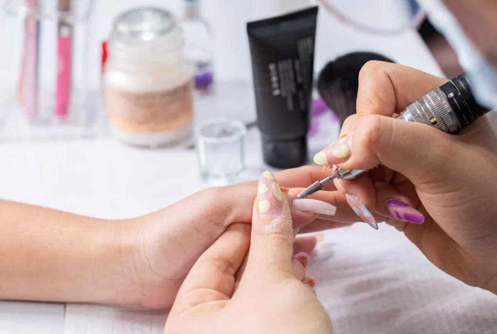 Applying cuticle oil for acrylic nail aftercare